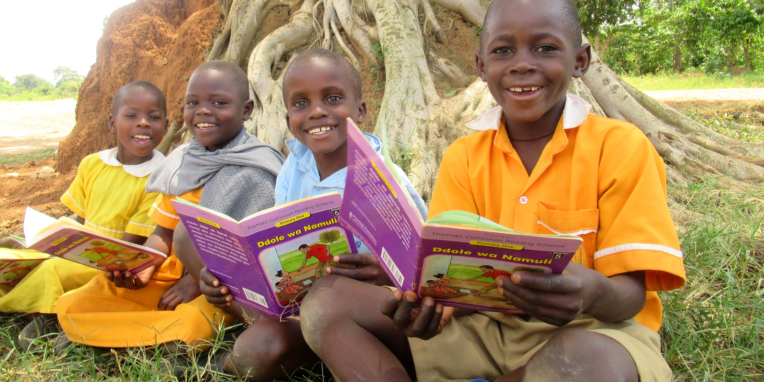 In Uganda, young children smile while holding books